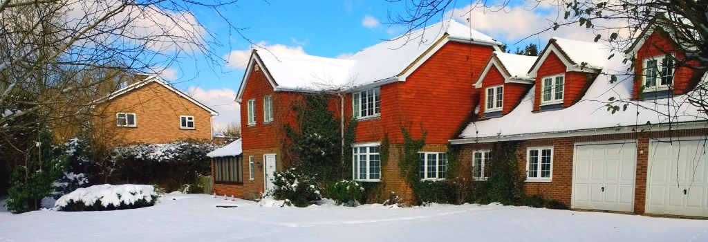 Pond House exterior covered in snow
